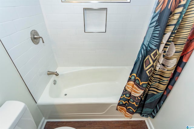 bathroom featuring toilet, shower / bath combo, and wood-type flooring