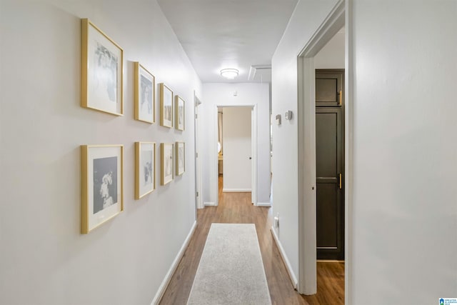 corridor with light hardwood / wood-style flooring