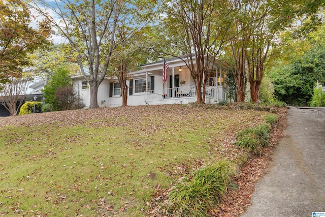 view of front of house with covered porch and a front yard