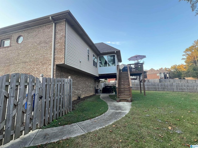 view of home's exterior featuring a yard and a deck