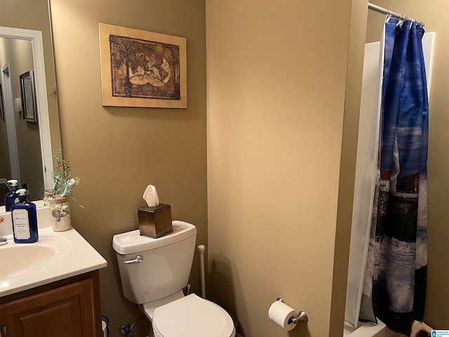 bathroom featuring vanity, toilet, and curtained shower