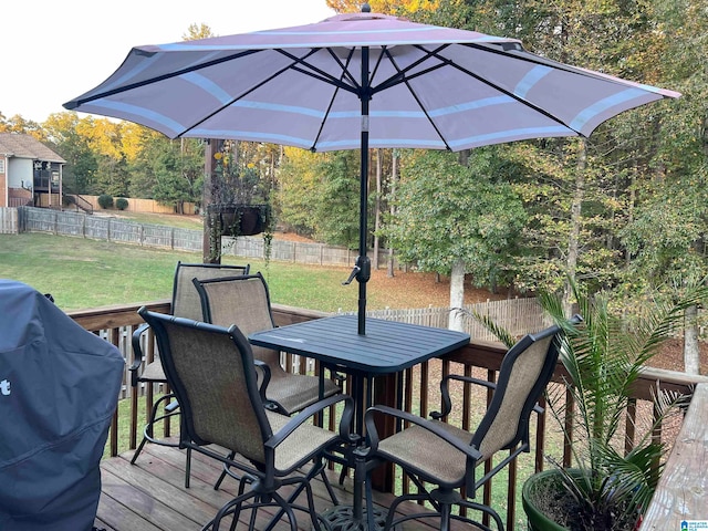 deck featuring area for grilling and a lawn