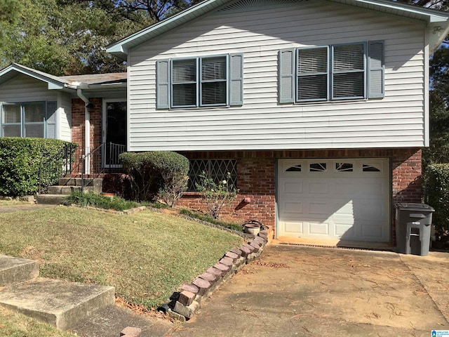 tri-level home with a garage and a front yard