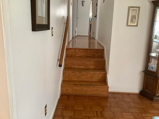 stairs featuring parquet floors