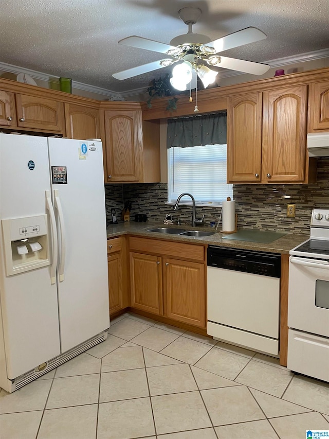 kitchen featuring white appliances, sink, light tile patterned floors, and crown molding