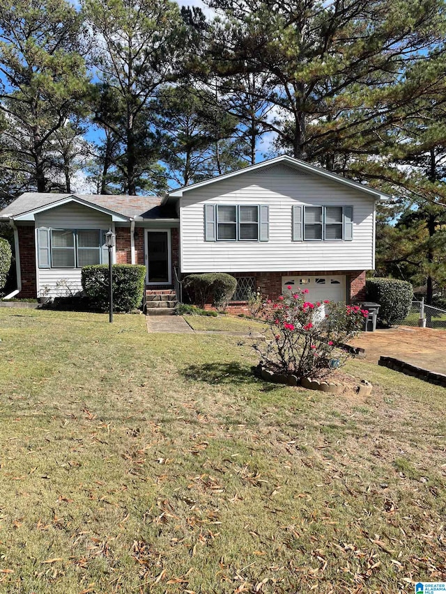 tri-level home with a garage and a front yard