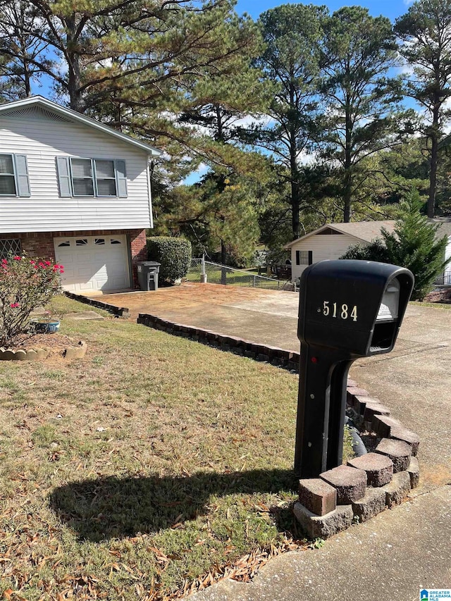 view of side of home featuring a lawn and a garage