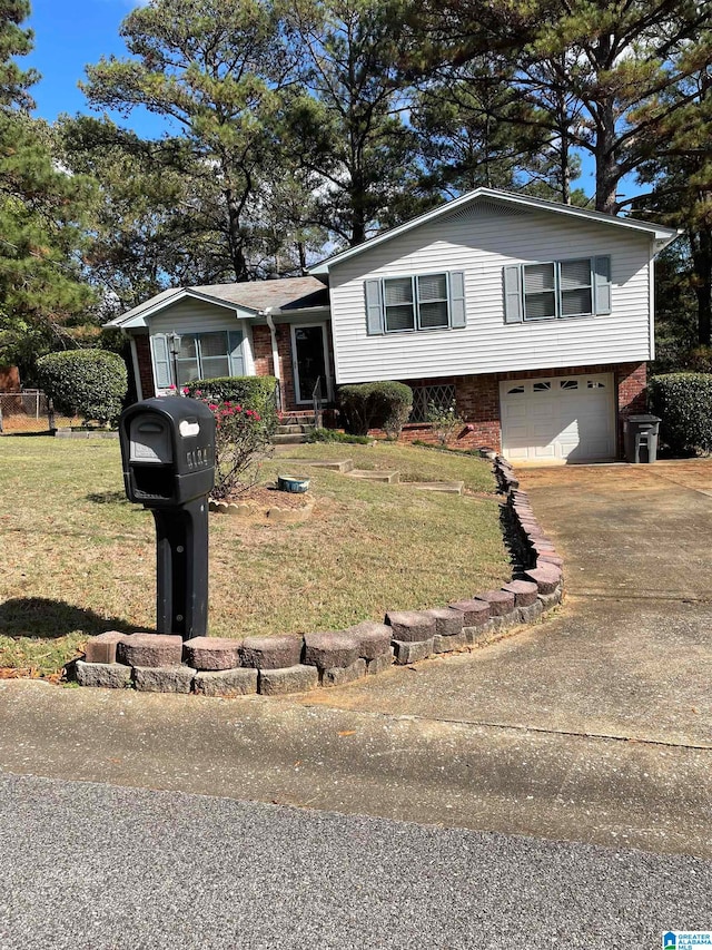 tri-level home featuring a front lawn and a garage