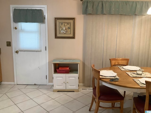 dining area with light tile patterned floors