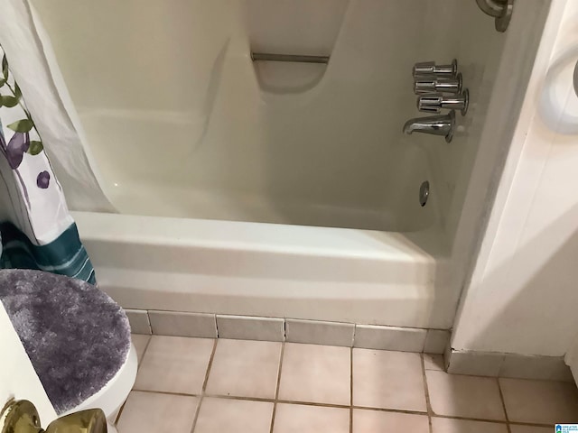 bathroom with tile patterned flooring and shower / bath combo