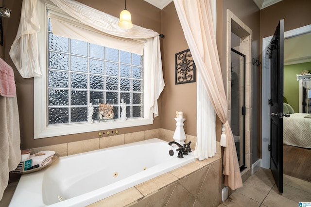 bathroom with ornamental molding, tile patterned flooring, and independent shower and bath