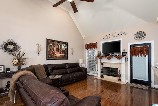 living room featuring hardwood / wood-style floors, ceiling fan, crown molding, and high vaulted ceiling