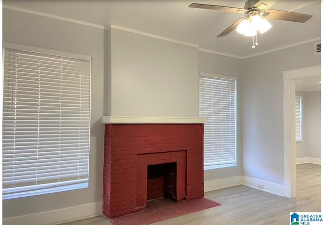 unfurnished living room featuring light hardwood / wood-style flooring, a fireplace, ceiling fan, and crown molding