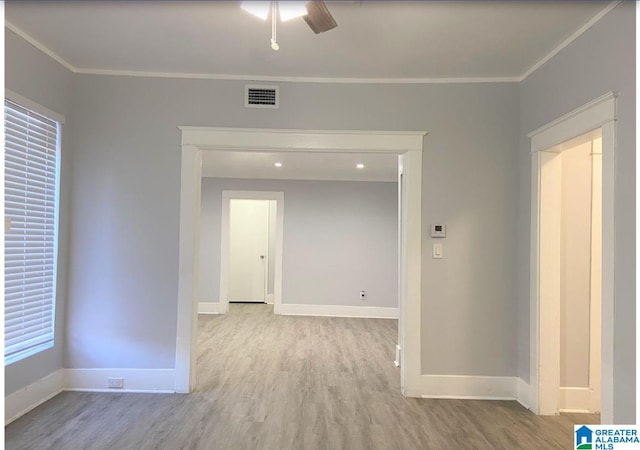 unfurnished room featuring ornamental molding, ceiling fan, and light hardwood / wood-style floors