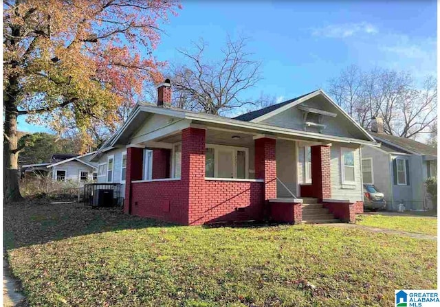 bungalow with a front yard and central AC