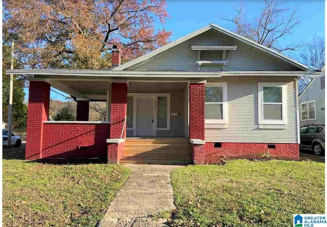 bungalow-style house featuring covered porch and a front yard