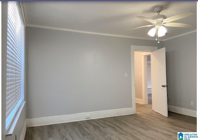 spare room with hardwood / wood-style floors, ceiling fan, and ornamental molding