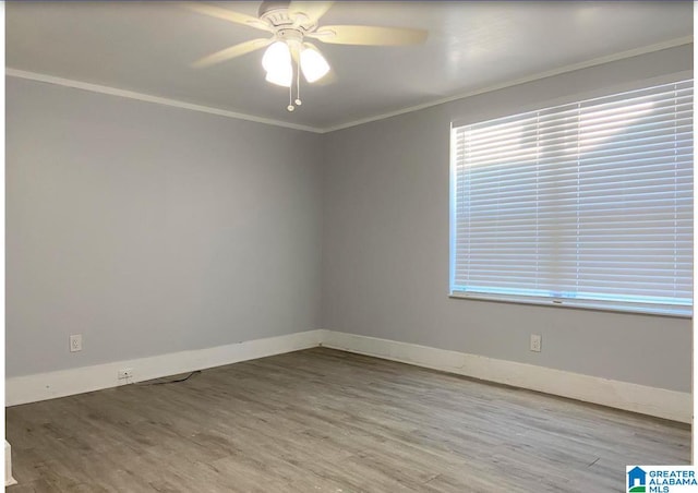 empty room featuring ceiling fan, hardwood / wood-style flooring, and ornamental molding