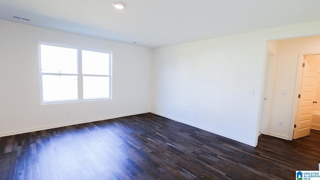 empty room featuring dark wood-type flooring