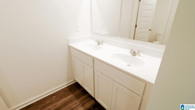 bathroom featuring vanity, hardwood / wood-style flooring, and toilet