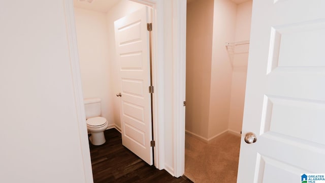 bathroom featuring hardwood / wood-style flooring and toilet