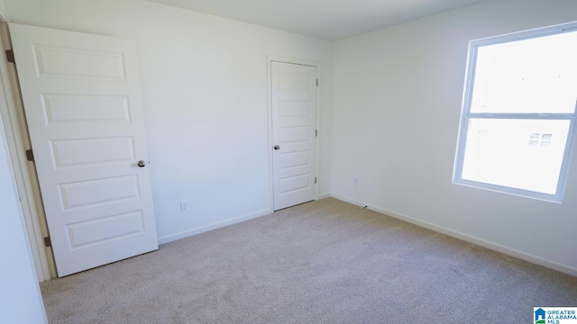 spare room with light colored carpet