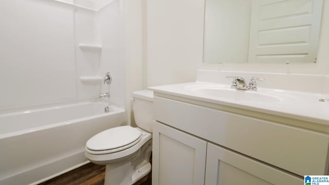 full bathroom with toilet, vanity, hardwood / wood-style flooring, and shower / washtub combination