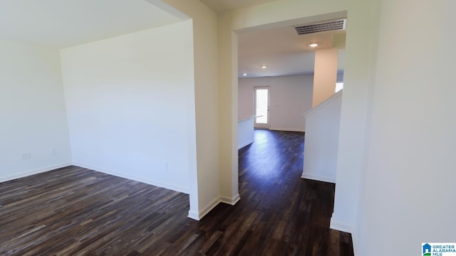 corridor with dark wood-type flooring