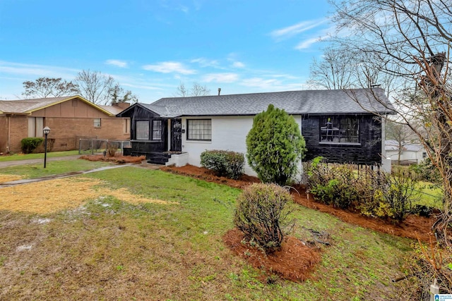 ranch-style house with a front lawn