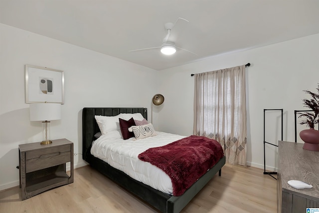 bedroom with light hardwood / wood-style floors and ceiling fan