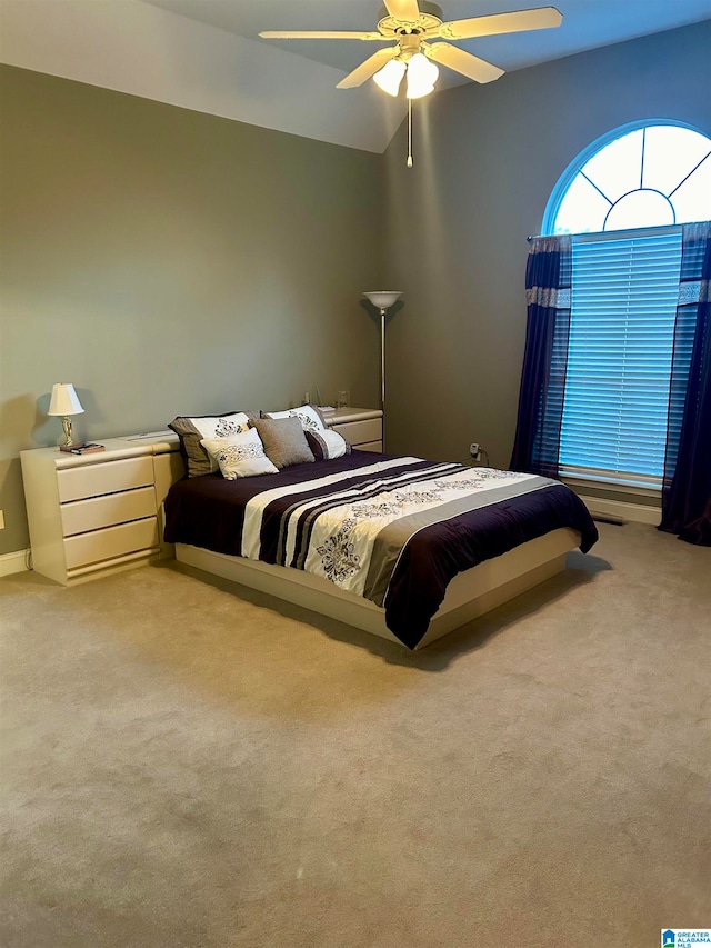 bedroom with ceiling fan and light carpet