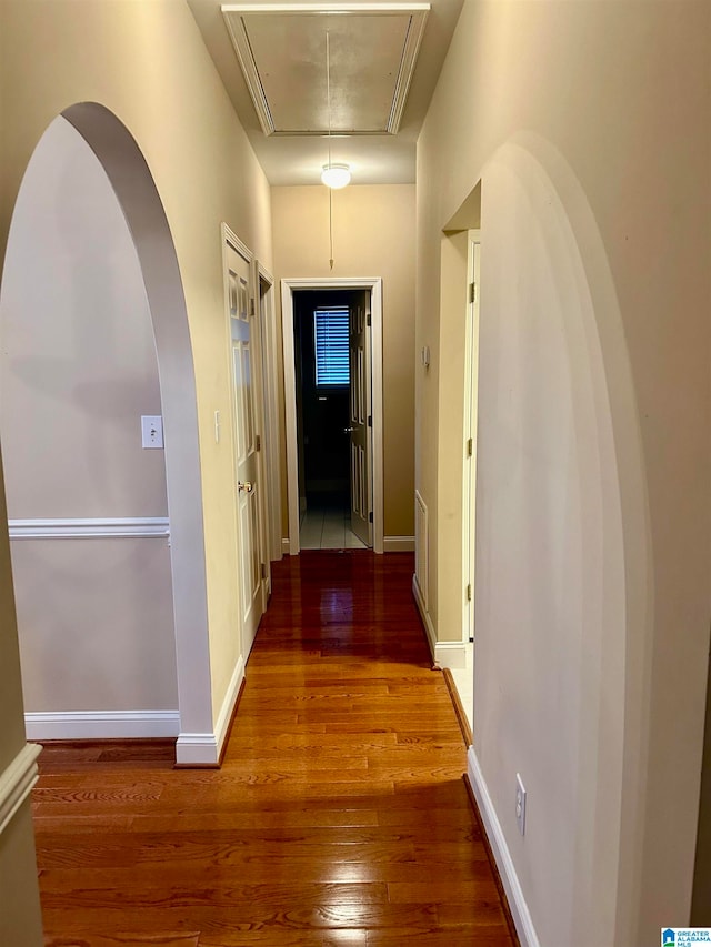 hallway with hardwood / wood-style flooring