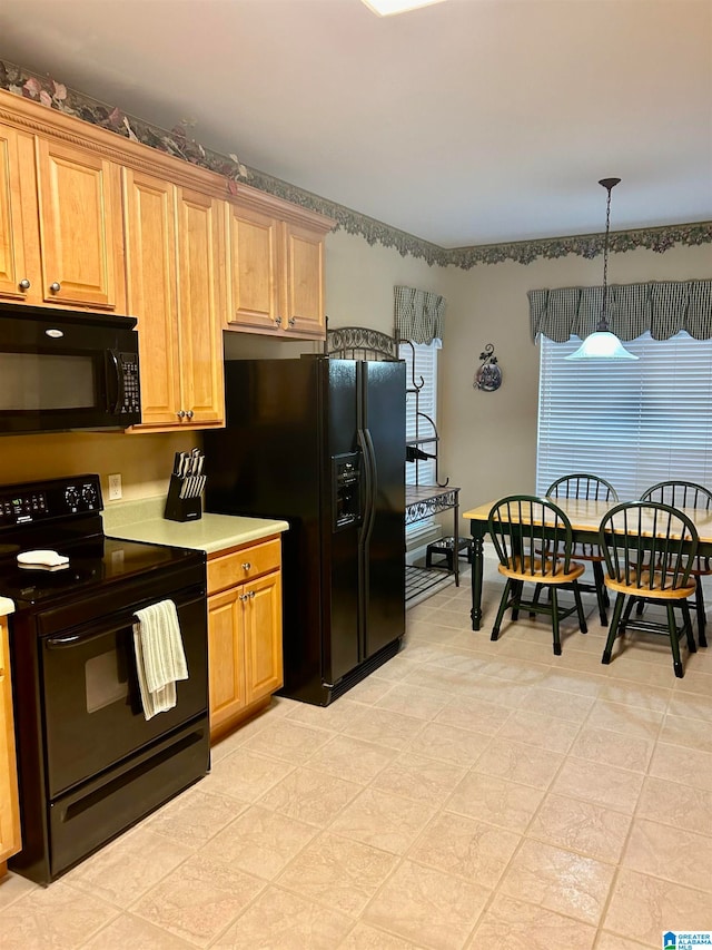 kitchen with black appliances and decorative light fixtures