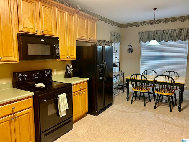 kitchen featuring hanging light fixtures and black appliances