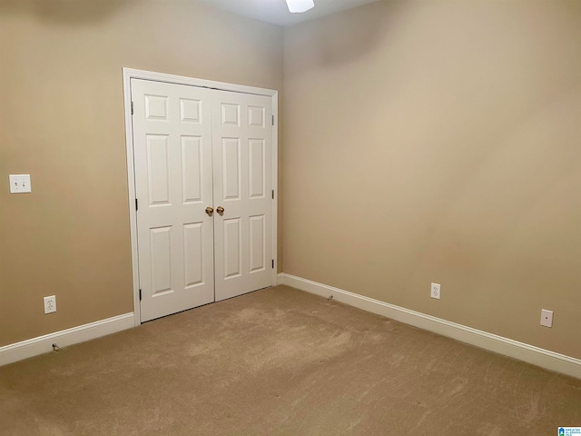 unfurnished bedroom with carpet floors and a closet