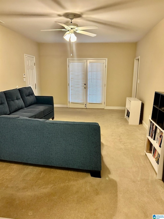 carpeted living room with ceiling fan