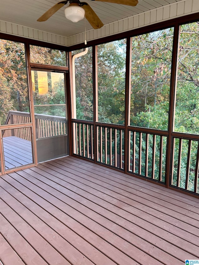 unfurnished sunroom with ceiling fan and a healthy amount of sunlight