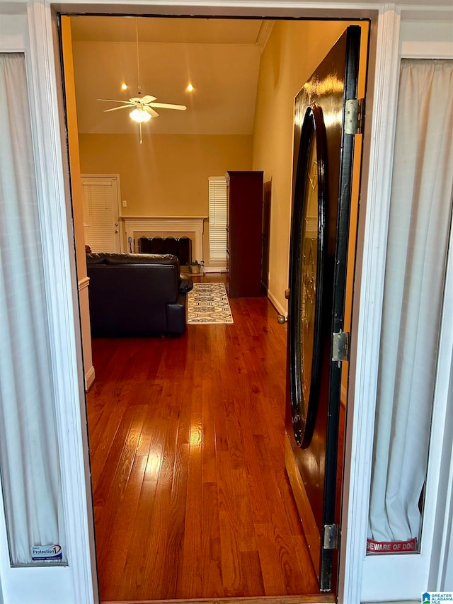 hallway with hardwood / wood-style flooring