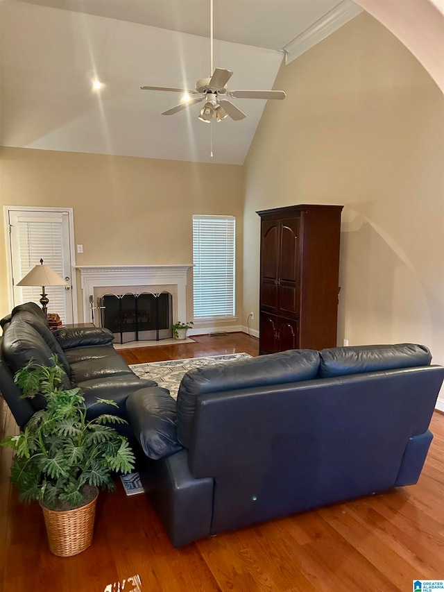 living room featuring lofted ceiling, hardwood / wood-style flooring, and ceiling fan