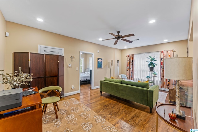 living room featuring ceiling fan and wood-type flooring