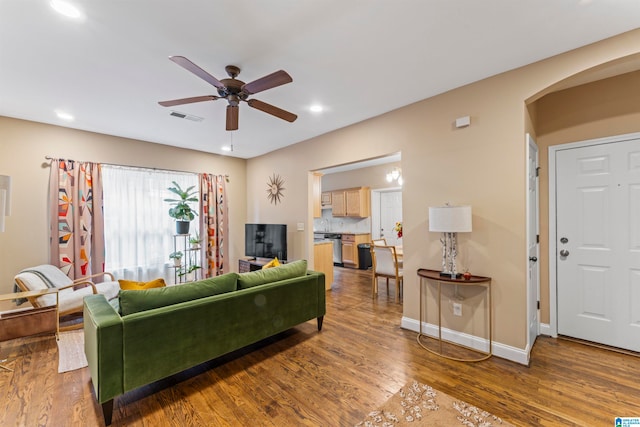 living room featuring ceiling fan and wood-type flooring