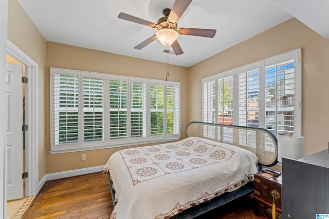 bedroom with ceiling fan and wood-type flooring