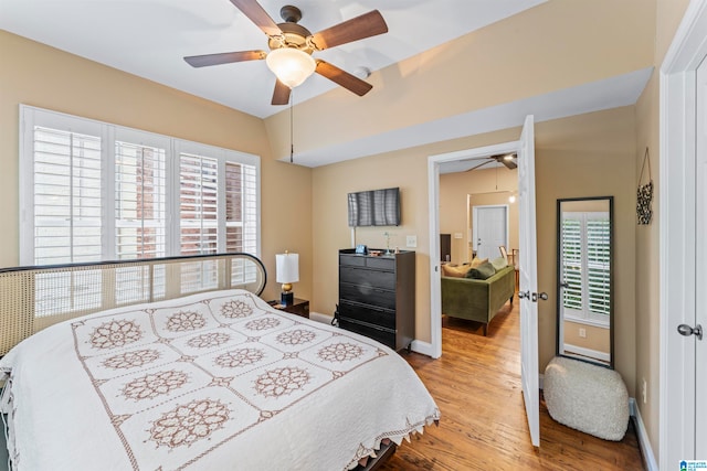 bedroom with light hardwood / wood-style floors and ceiling fan