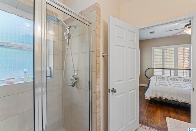 bathroom featuring an enclosed shower, hardwood / wood-style flooring, and ceiling fan