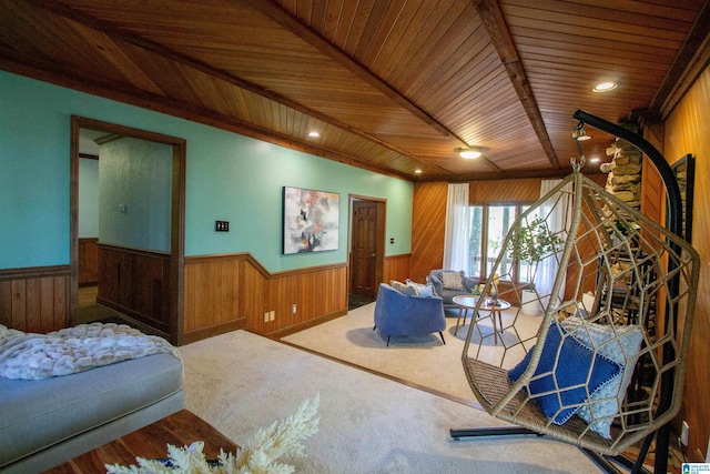 living room with carpet, wood ceiling, and wood walls