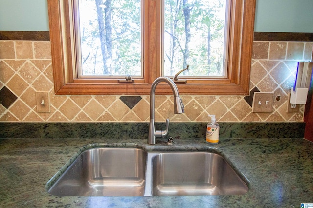 interior details featuring sink and stone countertops