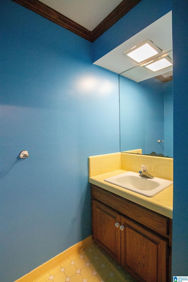 bathroom featuring crown molding and vanity