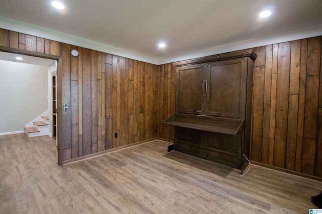 mudroom featuring light hardwood / wood-style floors and wood walls