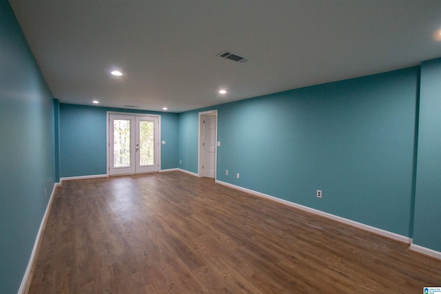 empty room featuring wood-type flooring and french doors