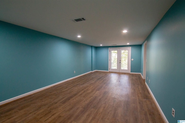 empty room featuring hardwood / wood-style flooring and french doors